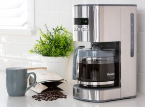 Kenmore stainless steel coffee filter machine with jug and a mug